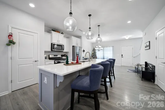 a view of kitchen with cabinets table and chairs