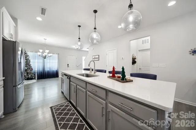 a kitchen with stainless steel appliances a sink stove and refrigerator