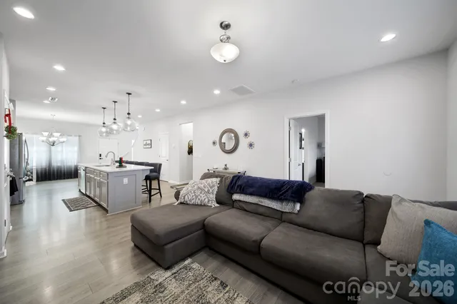 a living room with furniture and kitchen view