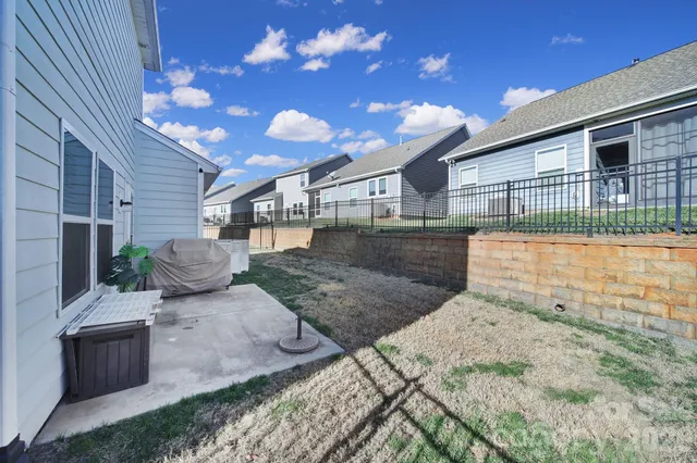 a view of a backyard with plants and outdoor seating