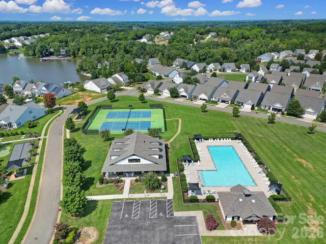 an aerial view of a house with a yard and lake view