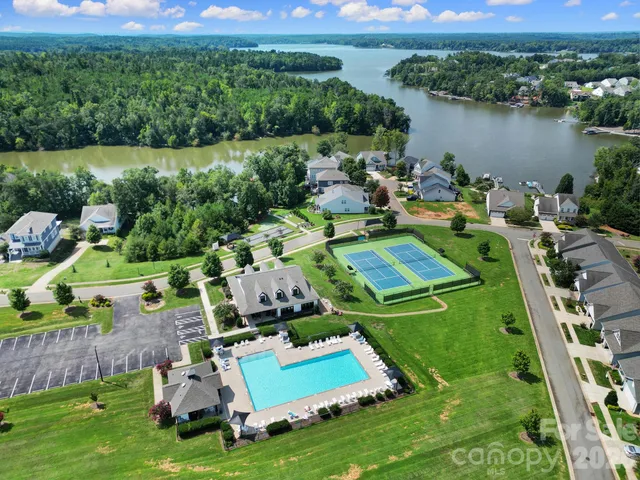 an aerial view of a house with a garden and lake view