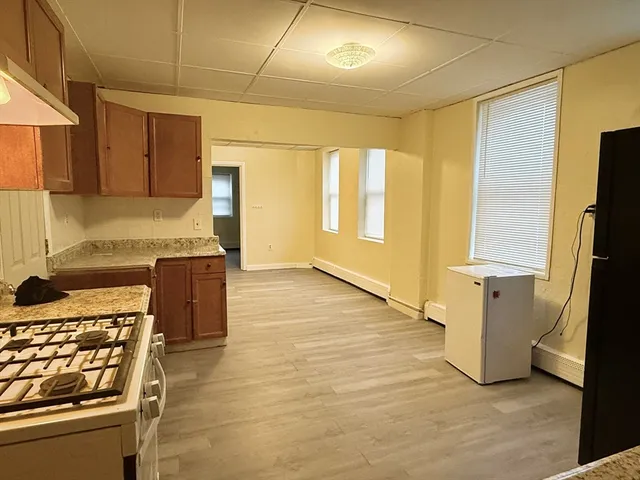 a kitchen with stainless steel appliances granite countertop a stove and a refrigerator