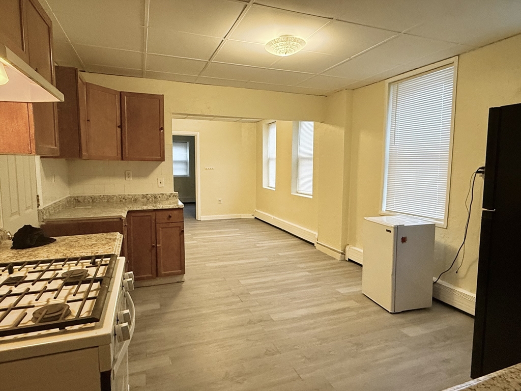 47 Williams Street, Unit 4 Chelsea, MA 02150 - Photo 2 of 10 a kitchen with stainless steel appliances granite countertop a stove and a refrigerator