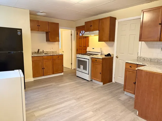 a kitchen with stainless steel appliances granite countertop a refrigerator stove and sink