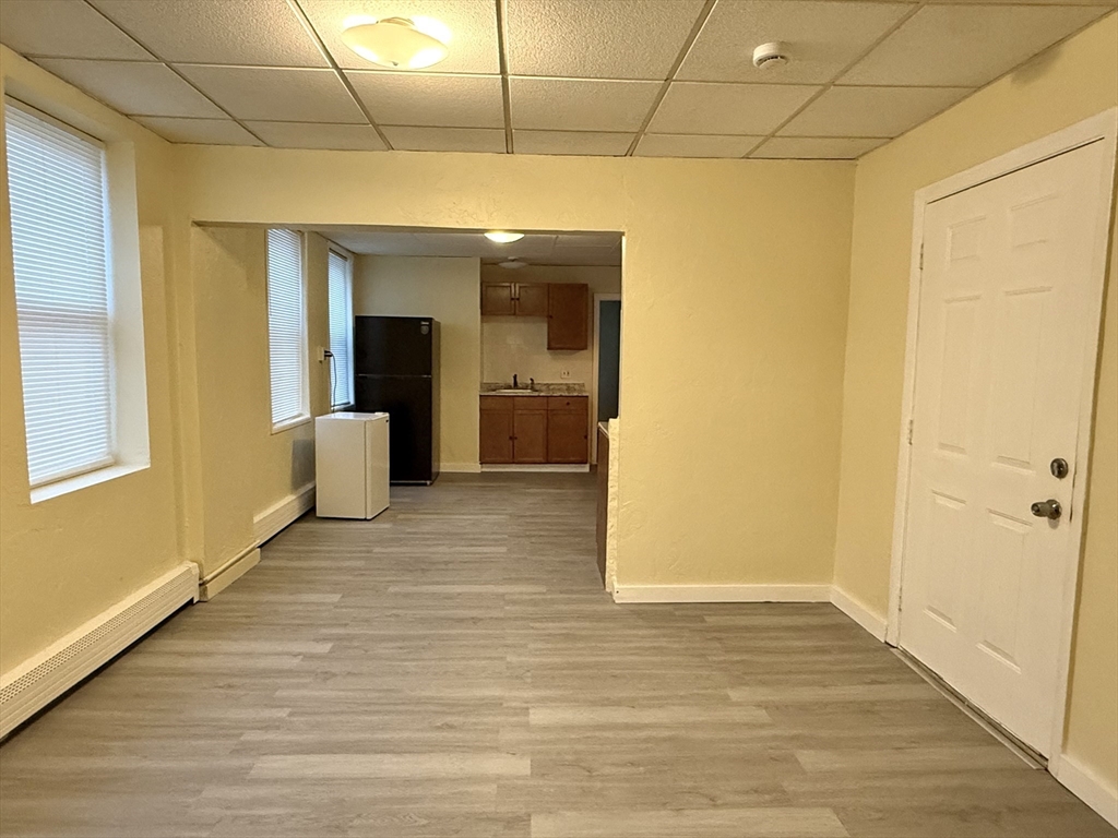 47 Williams Street, Unit 4 Chelsea, MA 02150 - Photo 4 of 10 a view of a big room with wooden floor and windows