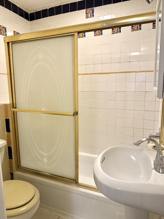 47 Williams Street, Unit 4 Chelsea, MA 02150 - Photo 5 of 10 a bathroom with a sink a toilet and shower