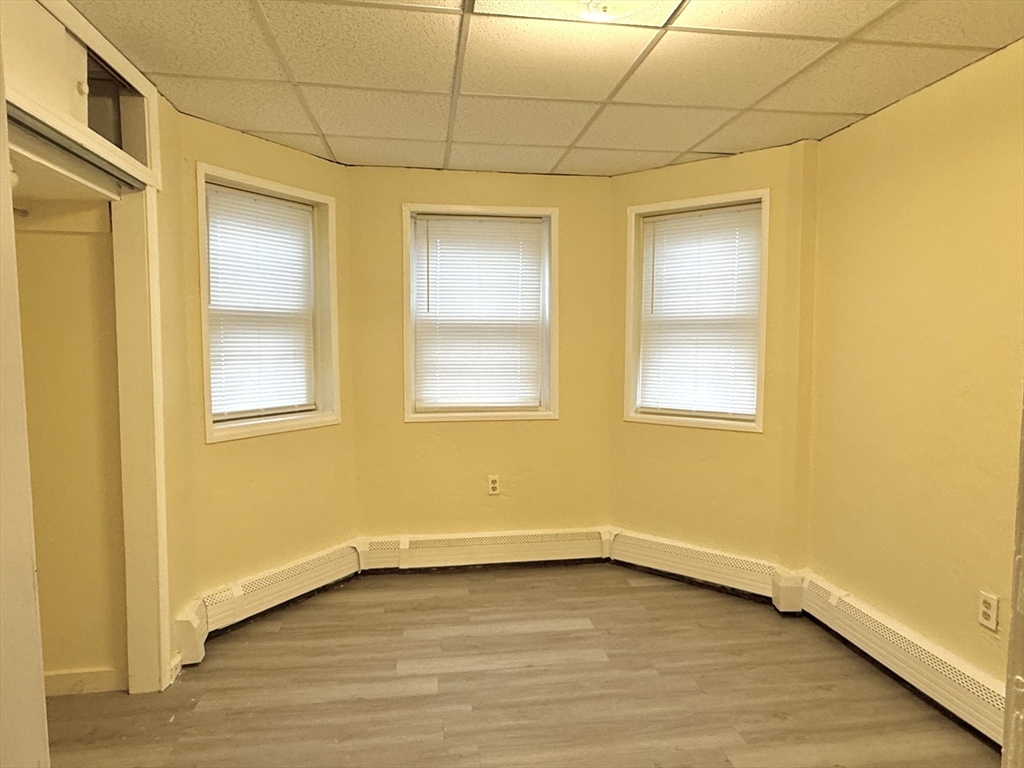 47 Williams Street, Unit 4 Chelsea, MA 02150 - Photo 6 of 10 a view of an empty room with wooden floor and a window