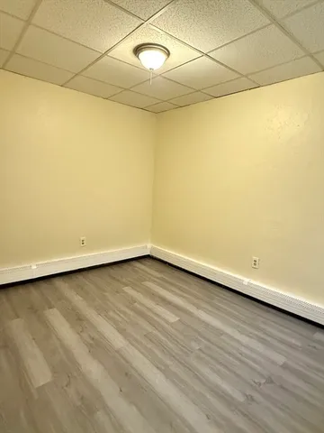 a view of a room with wooden floor and white walls