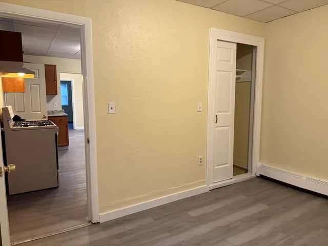 an empty room with wooden floor and closet