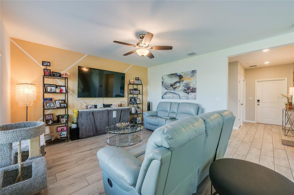 3986 Willowbrook Drive Edgewater, FL 32141 - Photo 12 of 57 a living room with furniture and a flat screen tv