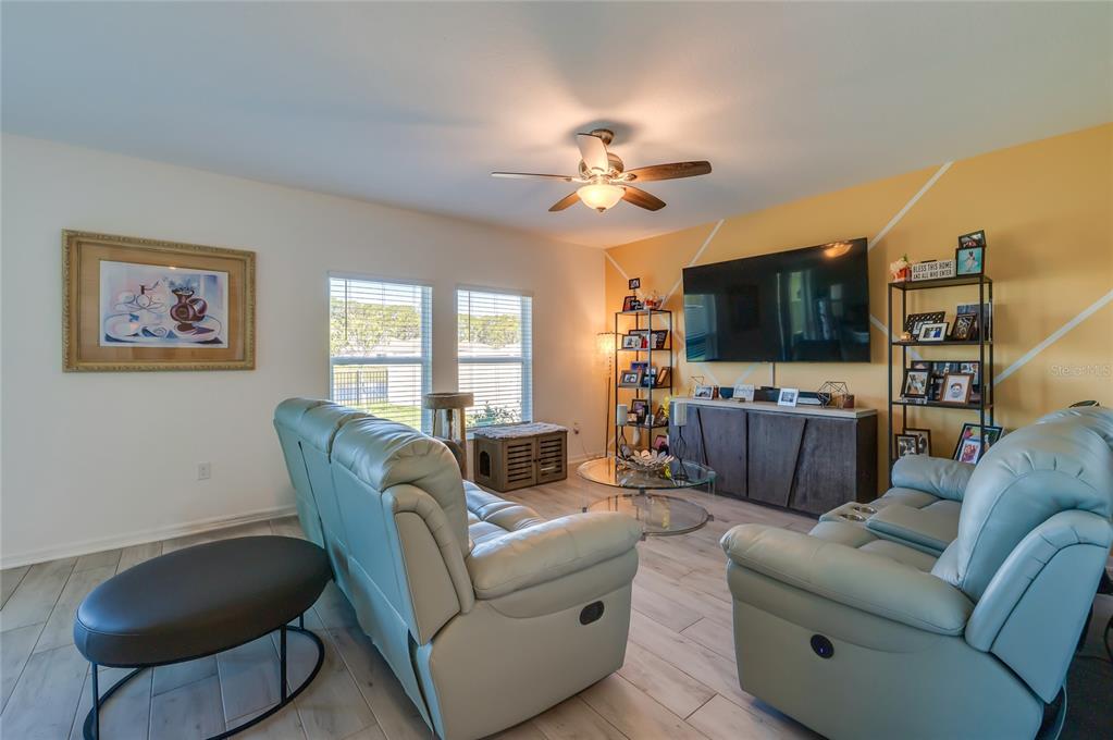 3986 Willowbrook Drive Edgewater, FL 32141 - Photo 13 of 57 a living room with furniture and a flat screen tv