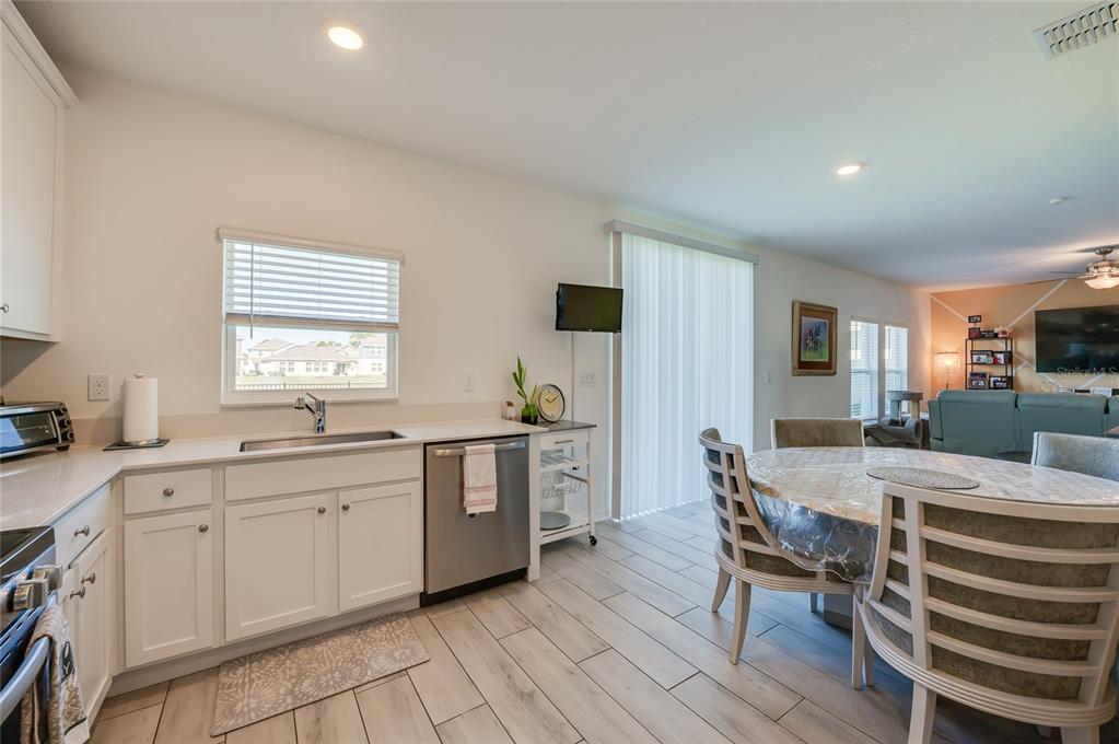 3986 Willowbrook Drive Edgewater, FL 32141 - Photo 15 of 57 a large kitchen with cabinets chairs and entryway