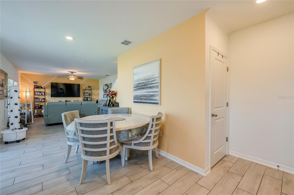 3986 Willowbrook Drive Edgewater, FL 32141 - Photo 16 of 57 a dining room with furniture and wooden floor