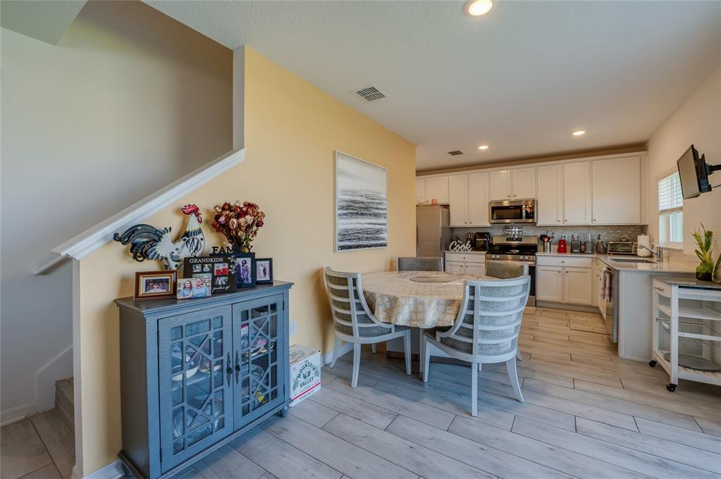 3986 Willowbrook Drive Edgewater, FL 32141 - Photo 17 of 57 a dining room with furniture and wooden floor