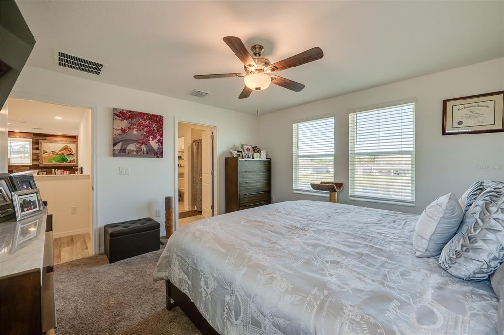 3986 Willowbrook Drive Edgewater, FL 32141 - Photo 22 of 57 a bedroom with a bed and a large mirror