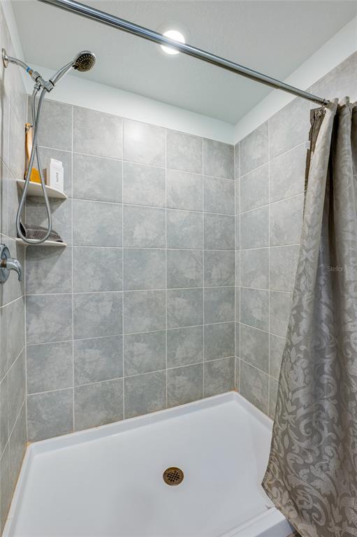 3986 Willowbrook Drive Edgewater, FL 32141 - Photo 24 of 57 a bathroom with a bathtub and a shower