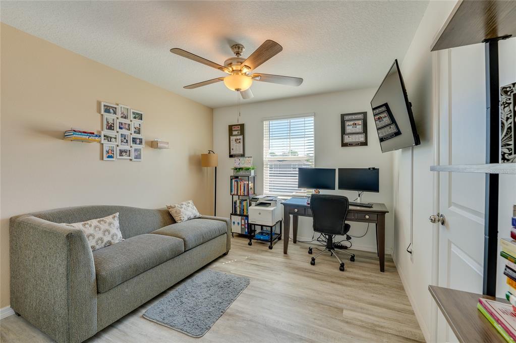 3986 Willowbrook Drive Edgewater, FL 32141 - Photo 28 of 57 a living room with furniture and a flat screen tv with wooden floor