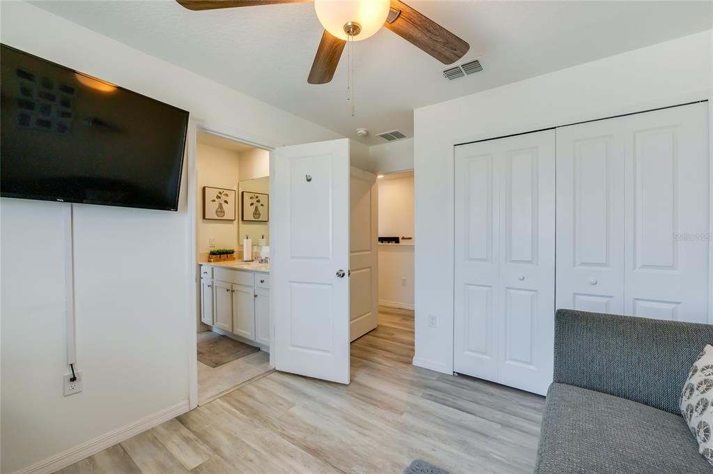 3986 Willowbrook Drive Edgewater, FL 32141 - Photo 29 of 57 a view of a livingroom with wooden floor and a ceiling fan
