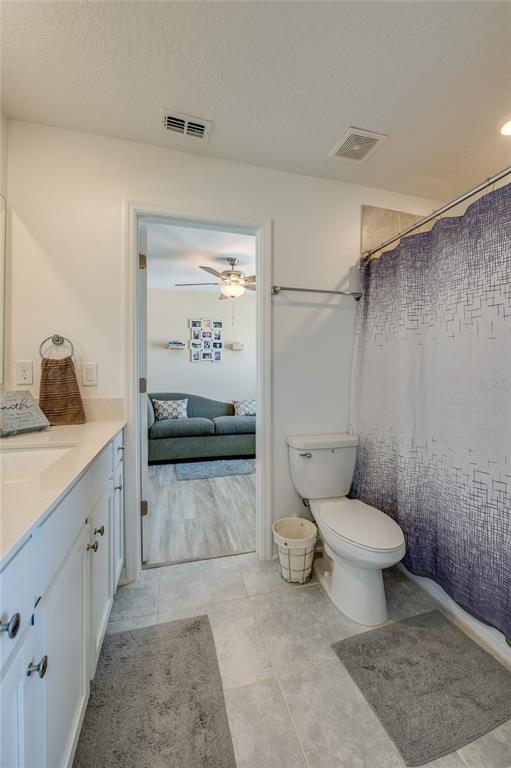 3986 Willowbrook Drive Edgewater, FL 32141 - Photo 32 of 57 a bathroom with a granite countertop toilet and a sink