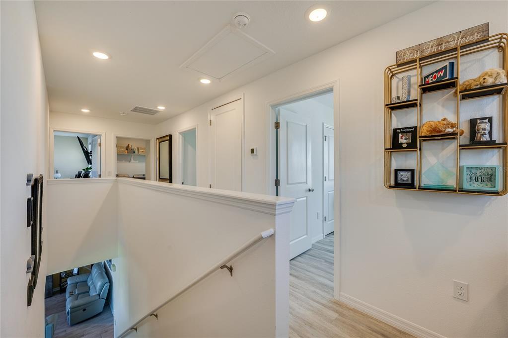 3986 Willowbrook Drive Edgewater, FL 32141 - Photo 36 of 57 a view of a hallway to room with wooden floor and windows