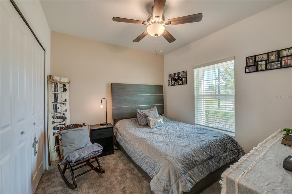 3986 Willowbrook Drive Edgewater, FL 32141 - Photo 9 of 57 a bedroom with a bed and a window