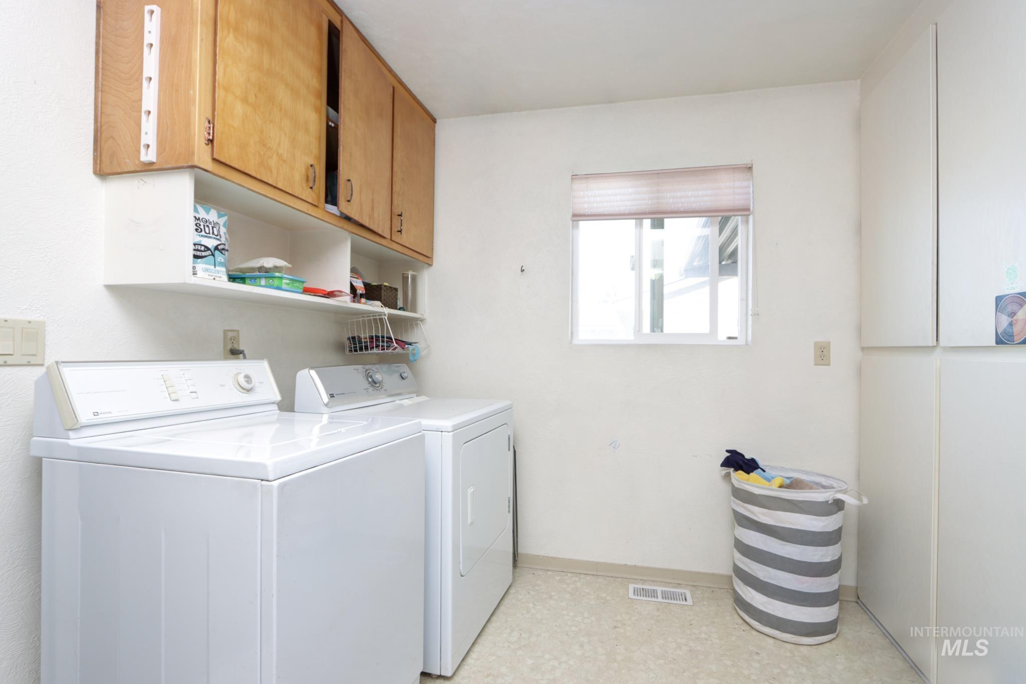 1302 Southwest 12th Street Ontario, OR 97914 - Photo 13 of 35 Laundry room featuring washer and clothes dryer and cabinet space