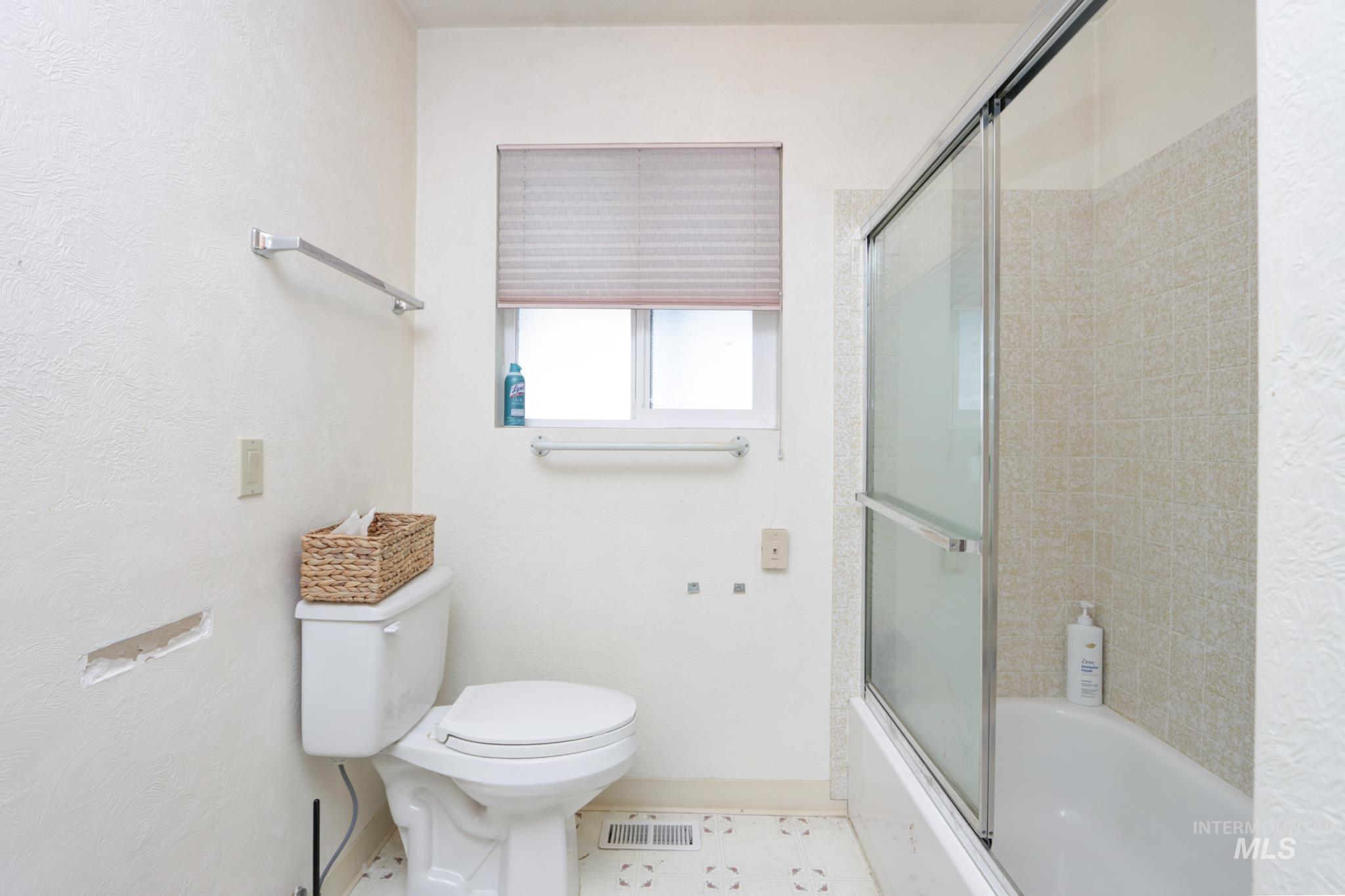 1302 Southwest 12th Street Ontario, OR 97914 - Photo 15 of 35 Bathroom featuring toilet and combined bath / shower with glass door
