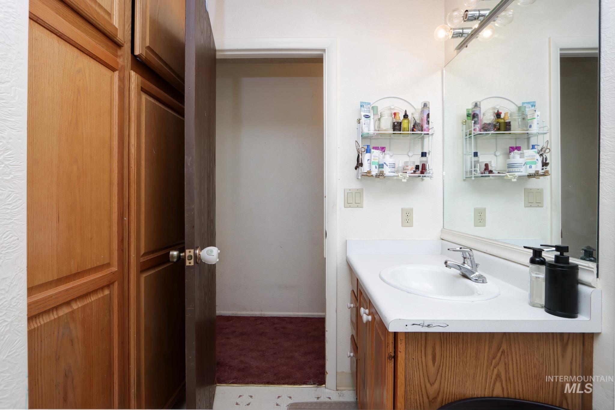 1302 Southwest 12th Street Ontario, OR 97914 - Photo 16 of 35 Bathroom with vanity and carpet