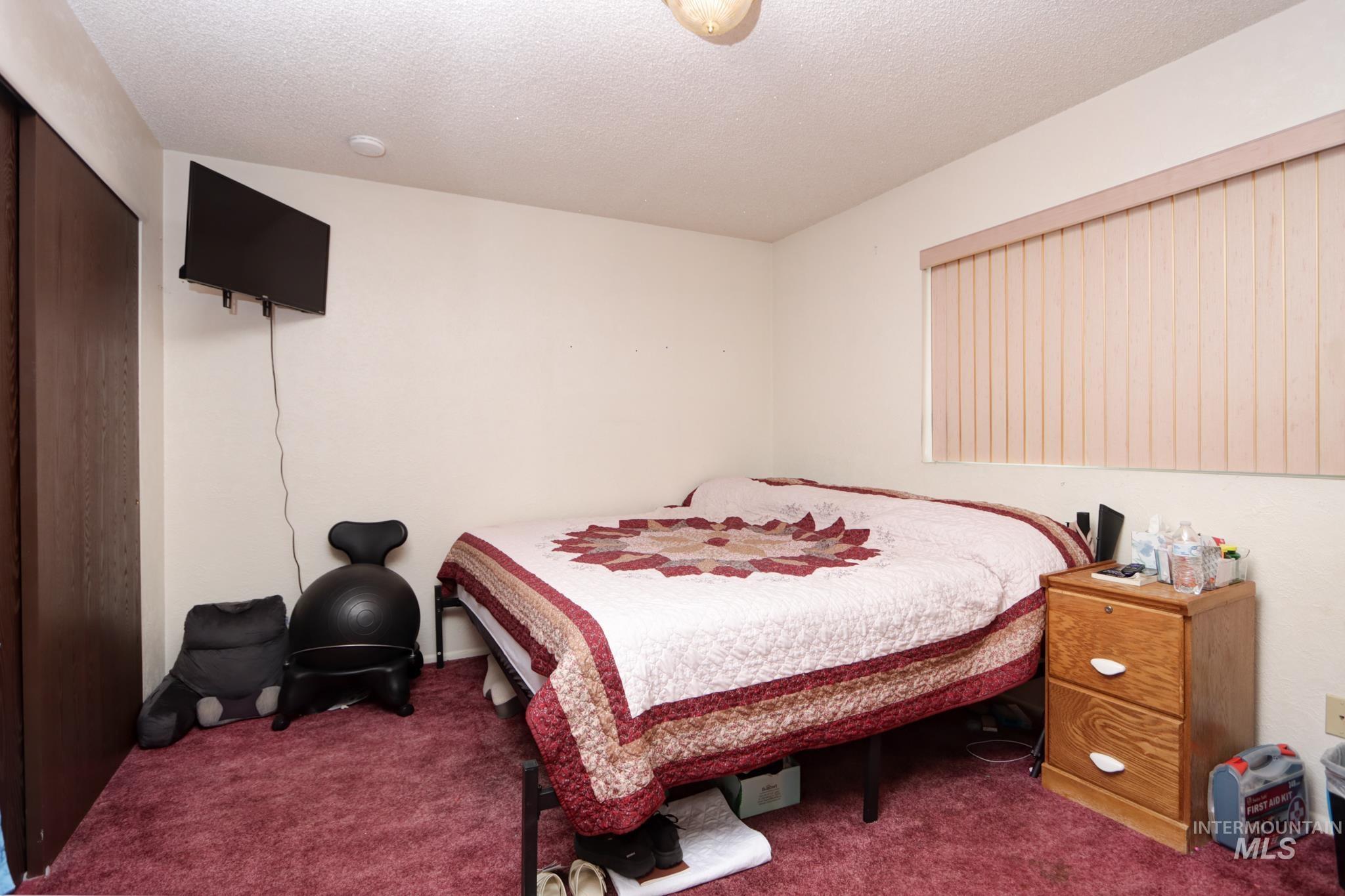 1302 Southwest 12th Street Ontario, OR 97914 - Photo 20 of 35 Carpeted bedroom with a textured ceiling