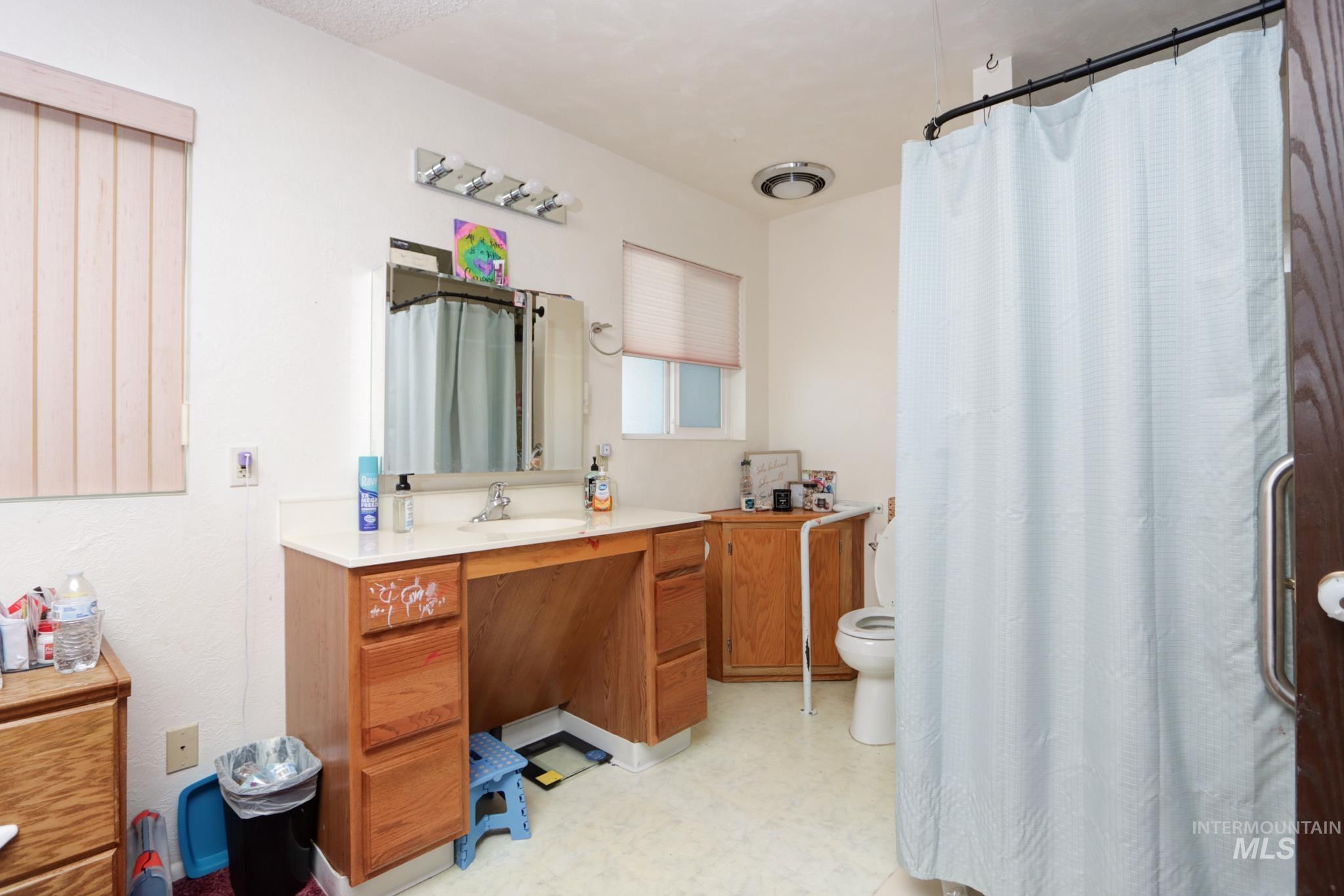 1302 Southwest 12th Street Ontario, OR 97914 - Photo 23 of 35 Bathroom featuring vanity, light floors, and a shower with curtain