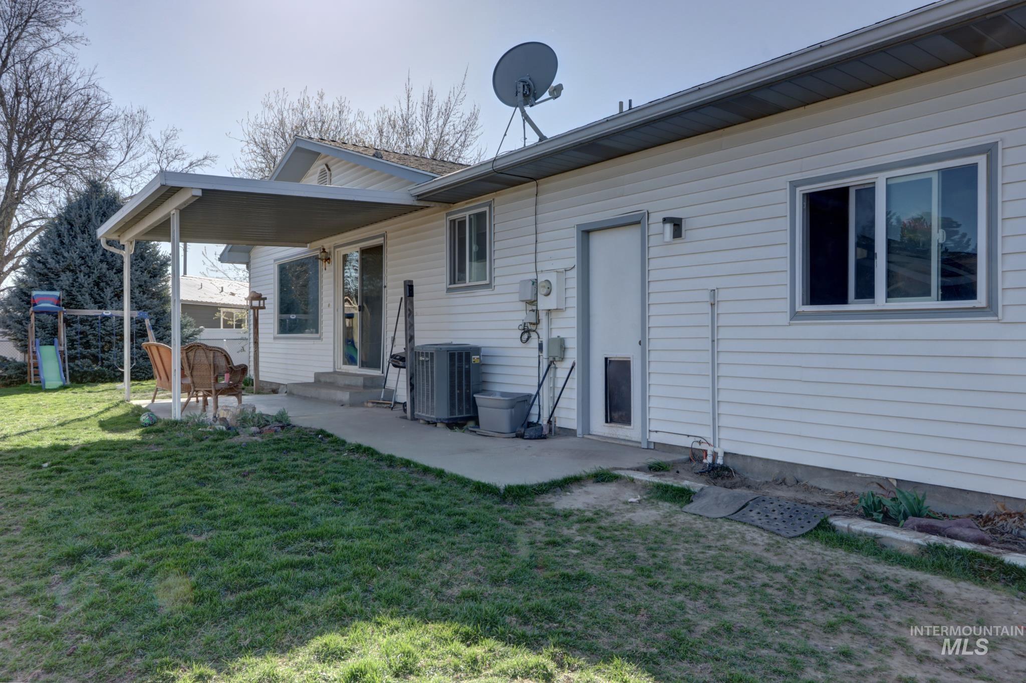 1302 Southwest 12th Street Ontario, OR 97914 - Photo 28 of 35 Back of property featuring a yard and entry steps