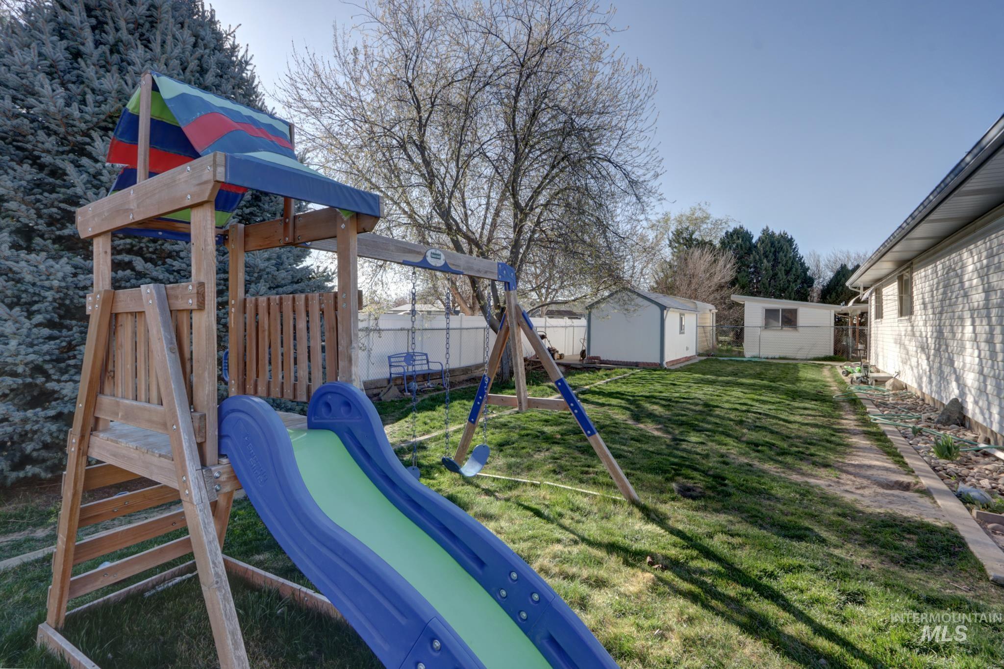 1302 Southwest 12th Street Ontario, OR 97914 - Photo 31 of 35 View of jungle gym with a storage unit and a fenced backyard