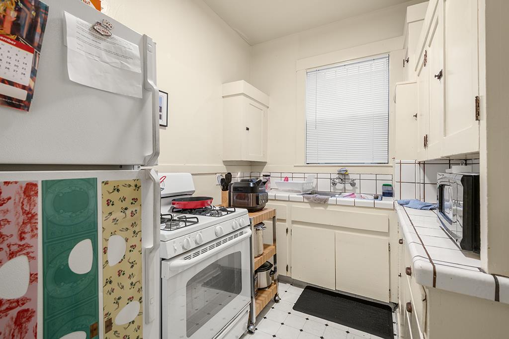 2874-2882 Telegraph Avenue Oakland, CA 94609 - Photo 11 of 18 a view of a kitchen with fridge and wooden floor