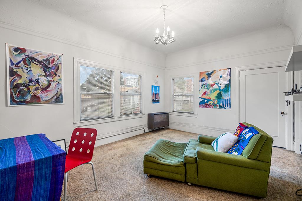 2874-2882 Telegraph Avenue Oakland, CA 94609 - Photo 12 of 18 a living room with furniture and a chandelier