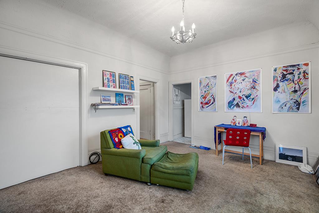 2874-2882 Telegraph Avenue Oakland, CA 94609 - Photo 13 of 18 a living room with furniture and a book shelf