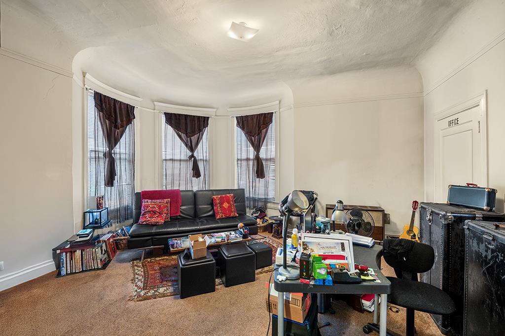 2874-2882 Telegraph Avenue Oakland, CA 94609 - Photo 5 of 18 a living room with furniture and a flat screen tv