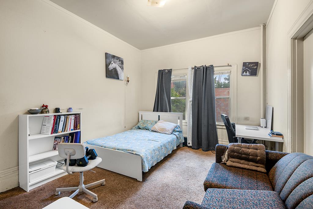 2874-2882 Telegraph Avenue Oakland, CA 94609 - Photo 7 of 18 a bedroom with a bed furniture and a window