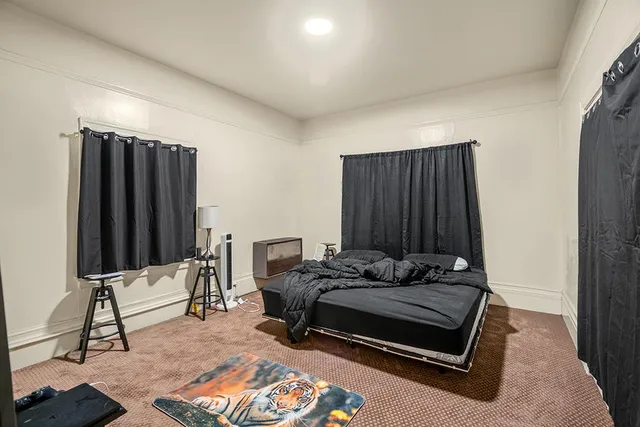 a view of a kitchen with fridge and wooden floor
