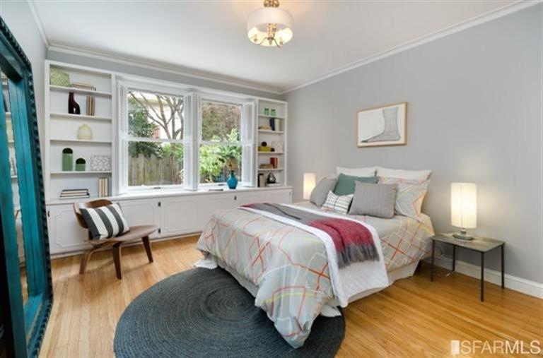 76 Rossi San Francisco, CA 94118 - Photo 7 of 30 A bedroom with built-in shelving and cabinets, as well as two closets, is at the rear of the house on the main level.