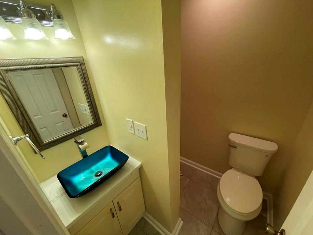 3190 Serenade Court Alpharetta, GA 30004 - Photo 16 of 41 a bathroom with a toilet and a mirror