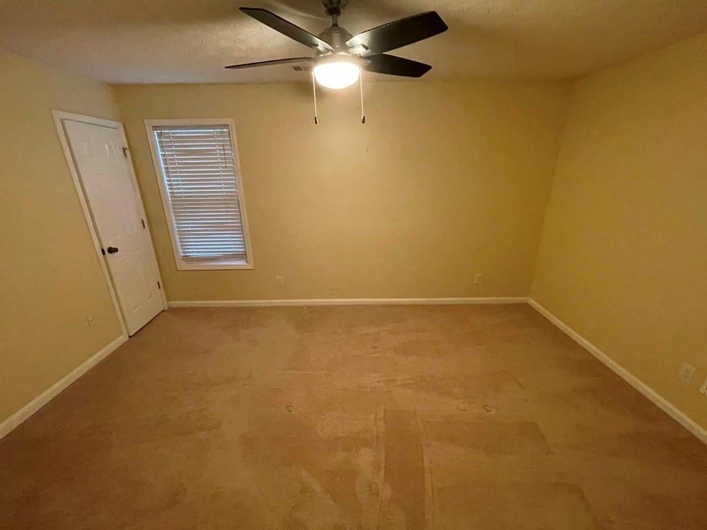 3190 Serenade Court Alpharetta, GA 30004 - Photo 19 of 41 en empty room with windows and fan