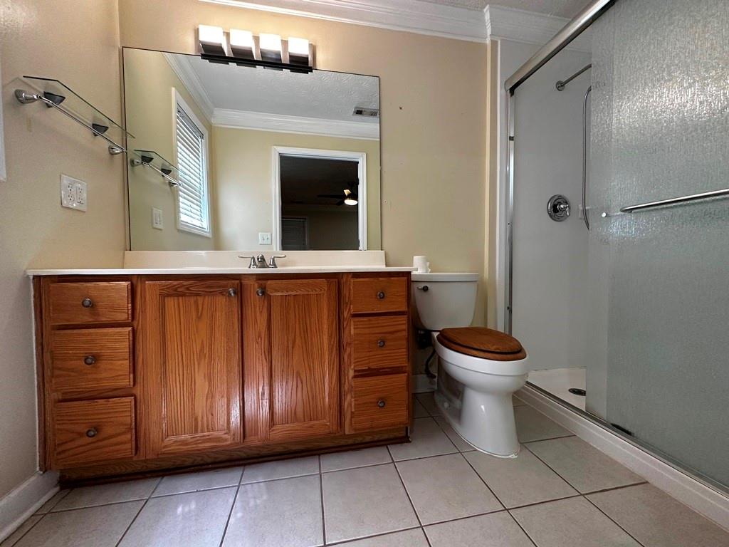 3190 Serenade Court Alpharetta, GA 30004 - Photo 20 of 41 a bathroom with a toilet a sink and shower