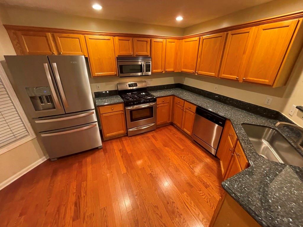 3190 Serenade Court Alpharetta, GA 30004 - Photo 3 of 41 a kitchen with stainless steel appliances granite countertop a stove a sink and a refrigerator
