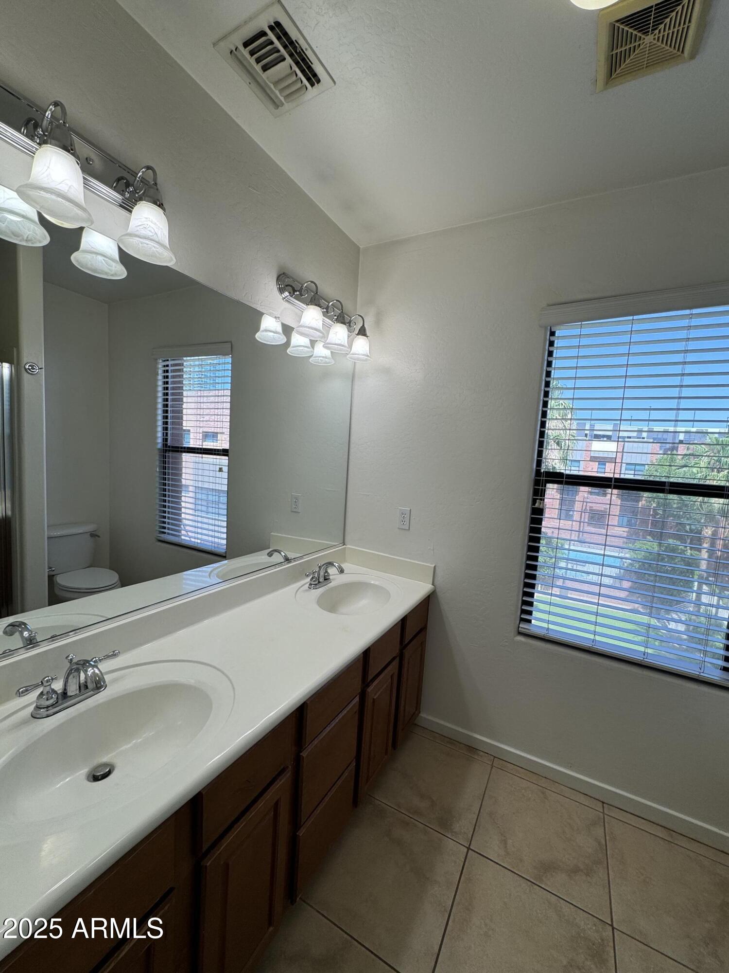 305 South Wilson Street, Unit 111 Tempe, AZ 85281 - Photo 21 of 48 a bathroom with a sink and a mirror