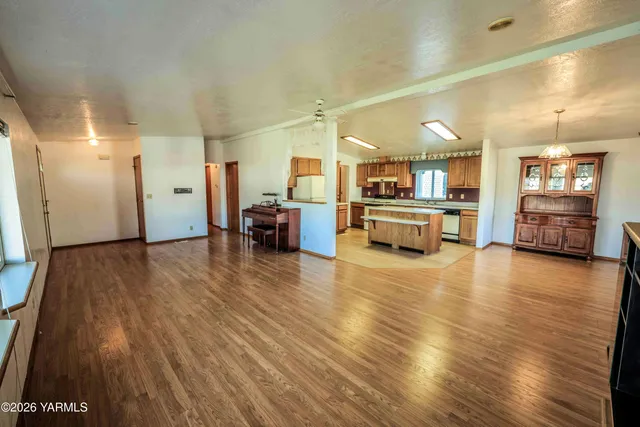 a view of a kitchen with furniture and wooden floor