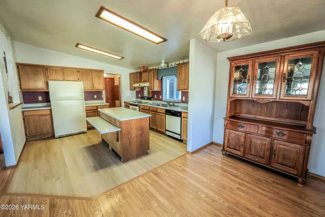 a kitchen with stainless steel appliances granite countertop a sink and refrigerator