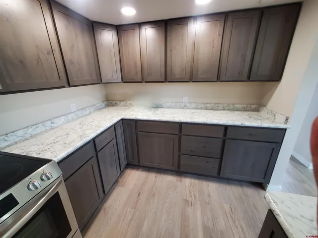 a kitchen with stainless steel appliances granite countertop wooden cabinets a sink and dishwasher