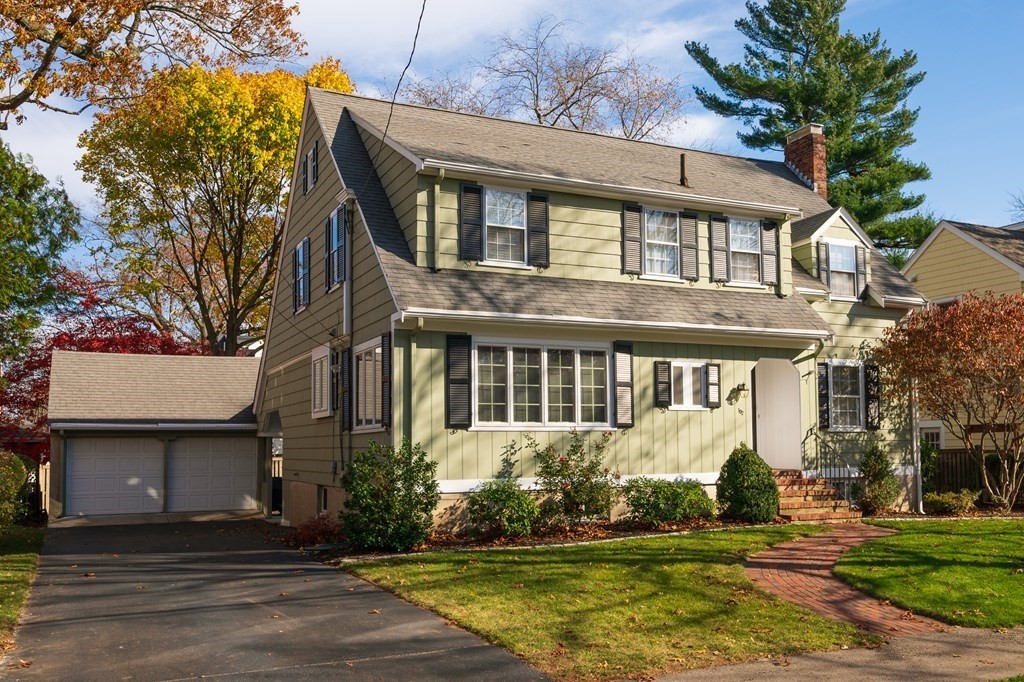 102 Governors Road Milton, MA 02186 - Photo 2 of 38 a front view of a house with a yard and garage