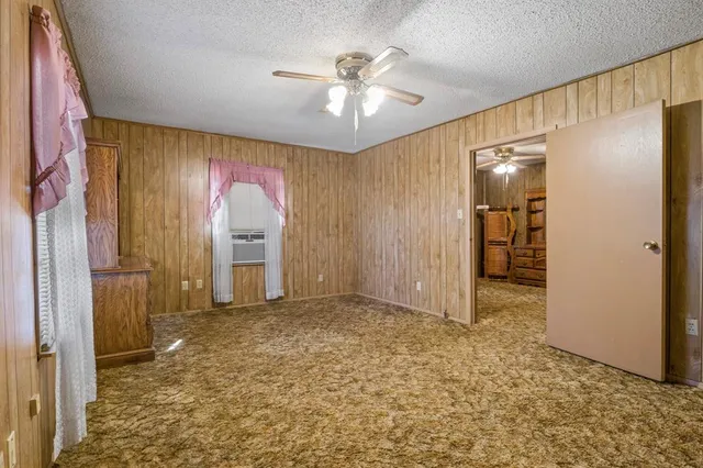 wooden floor in an empty room with a bathroom